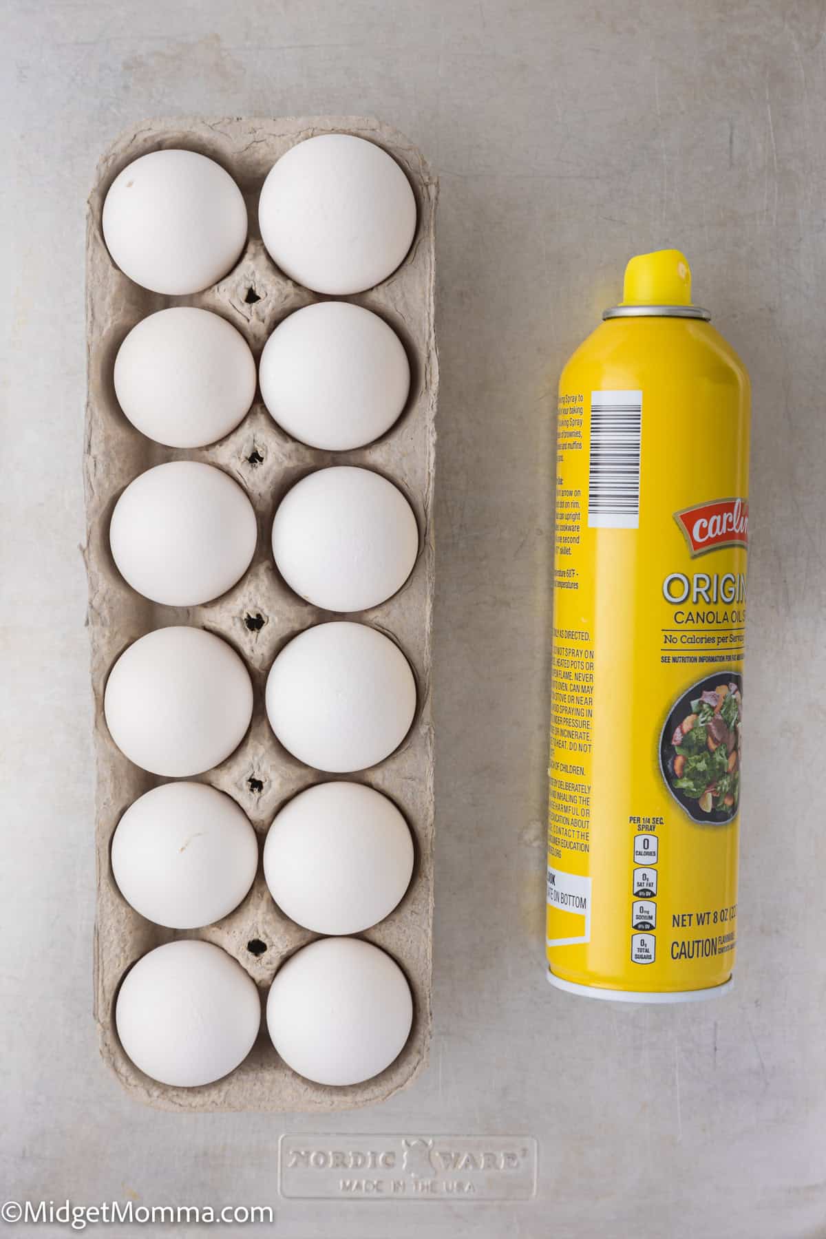 A carton holding 10 white eggs is placed next to a yellow can of non-stick cooking spray on a light gray surface.