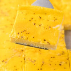 A spatula holds a square slice of sheet pan scrambled eggs.