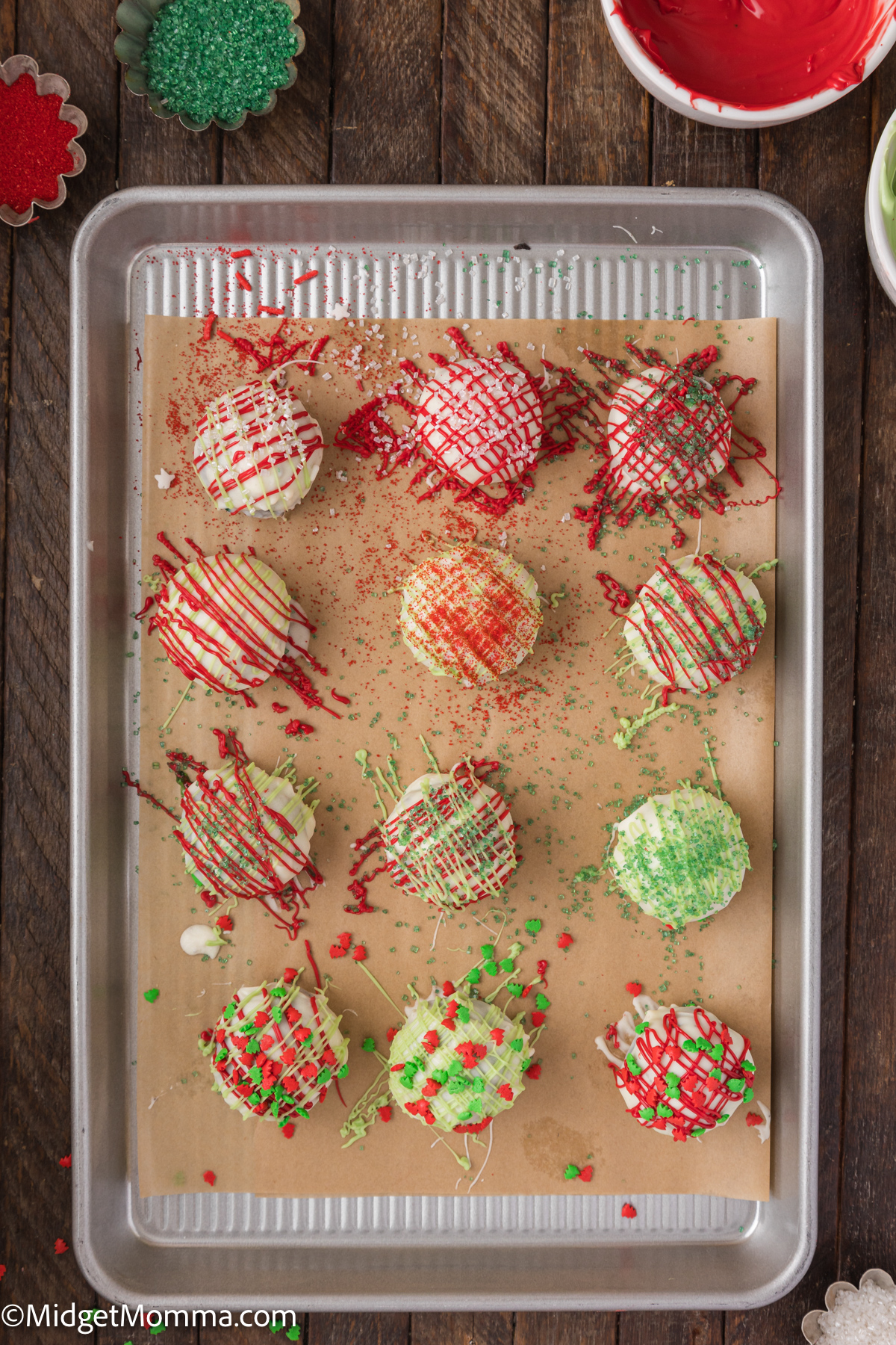 Oreo Balls being decorated on a baking sheet. 