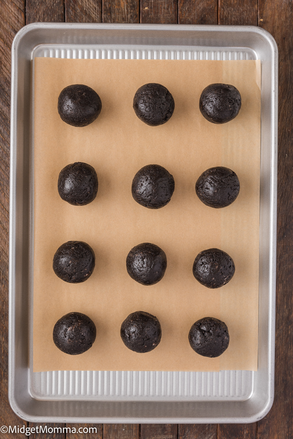 oreo balls uncovered in chocolate on a baking sheet