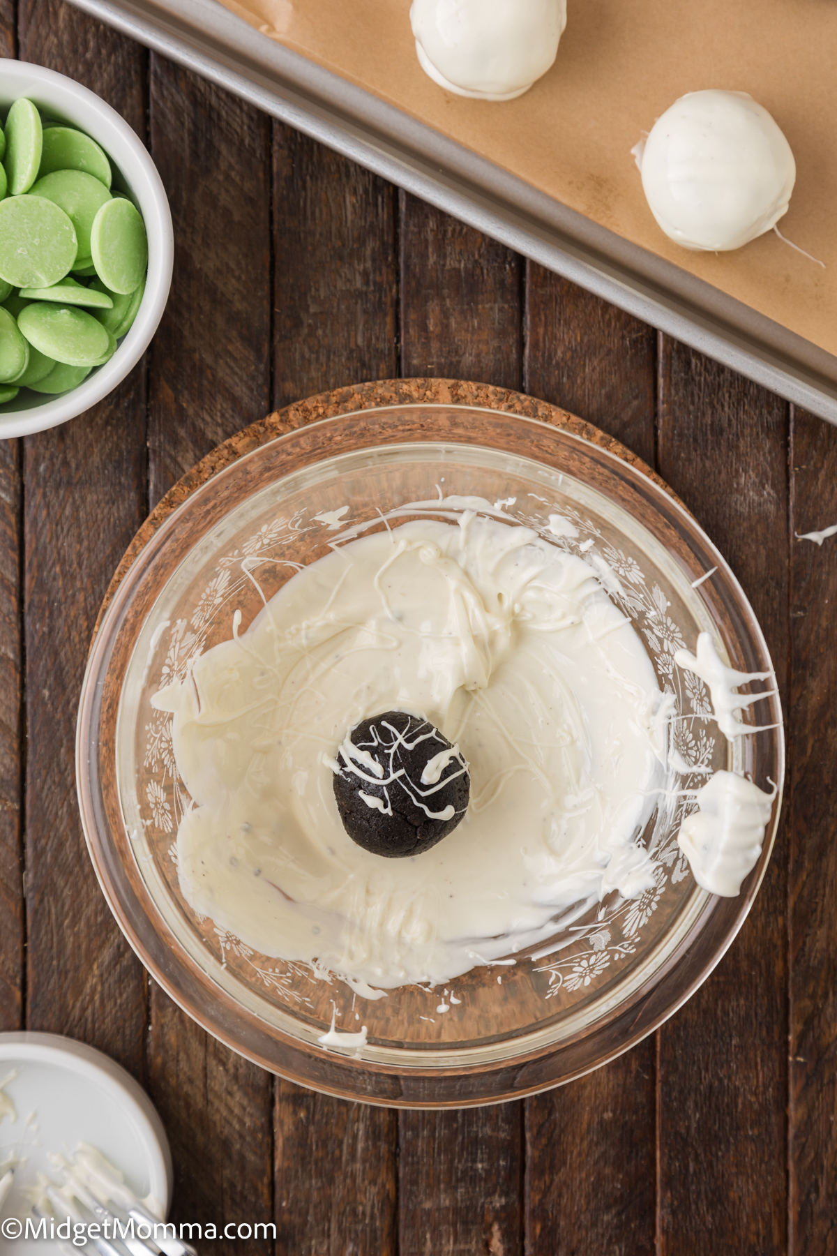 Oreo Ball in a bowl of melted white chocolate 