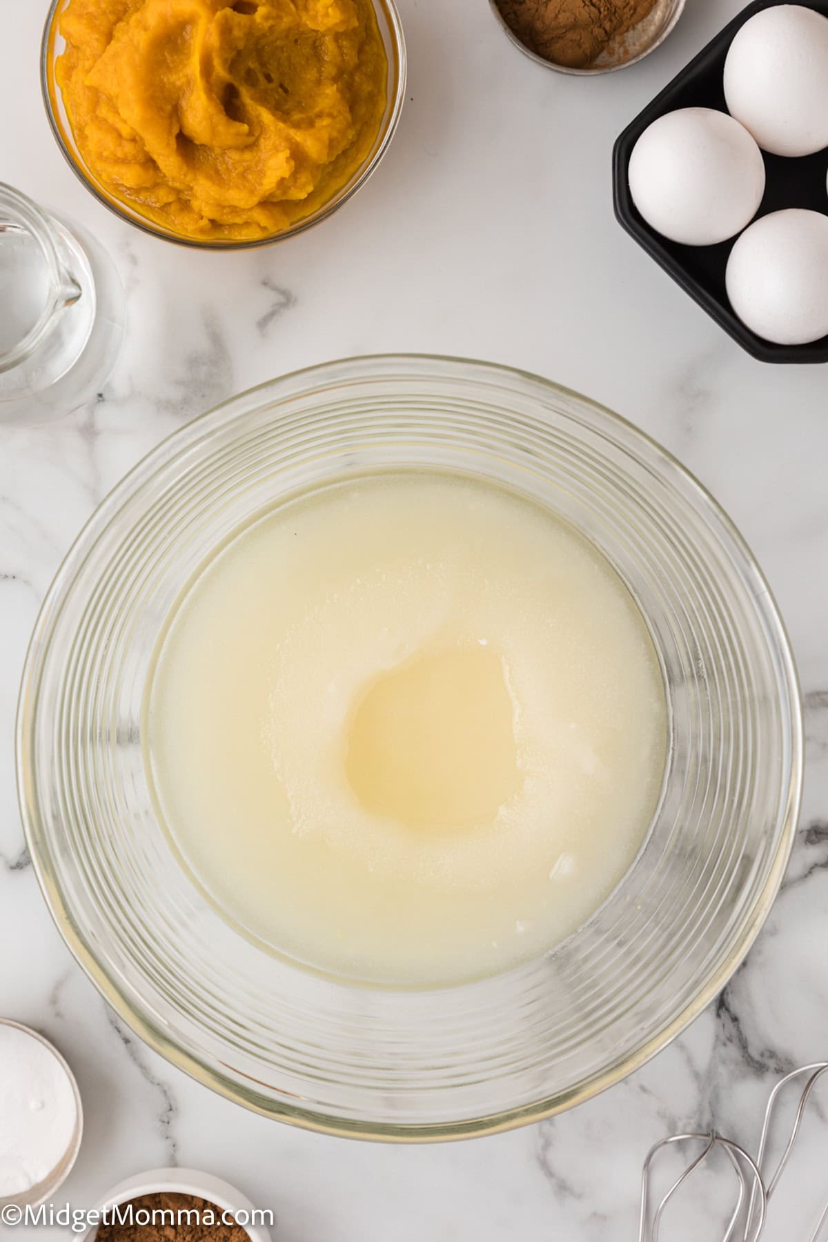 oil and sugar in a clear mixing bowl